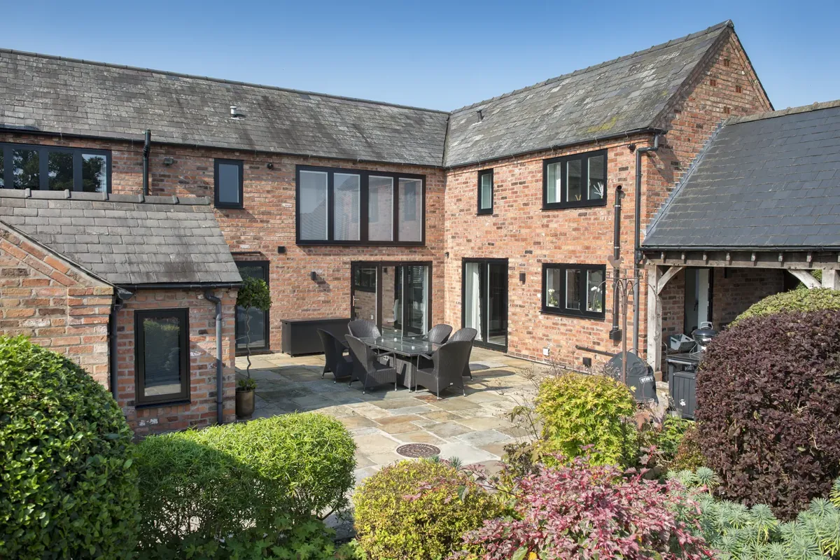 Aluminium windows around a brick courtyard