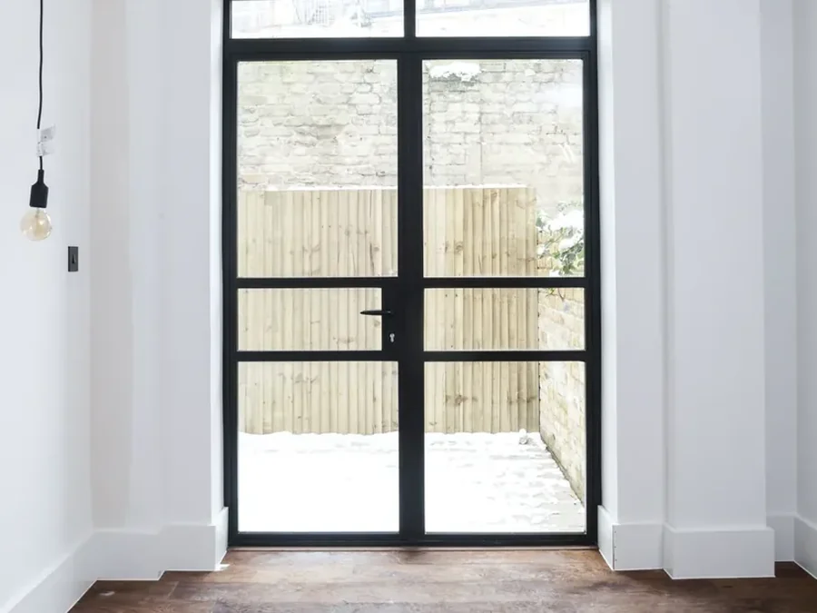 Aluminium entrance doors onto a courtyard