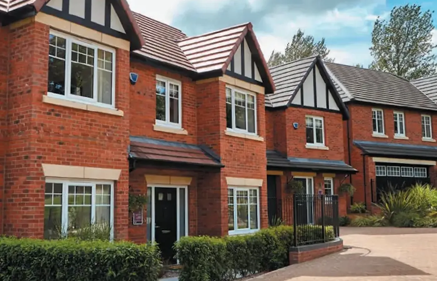 New white windows fitted across a red brick house