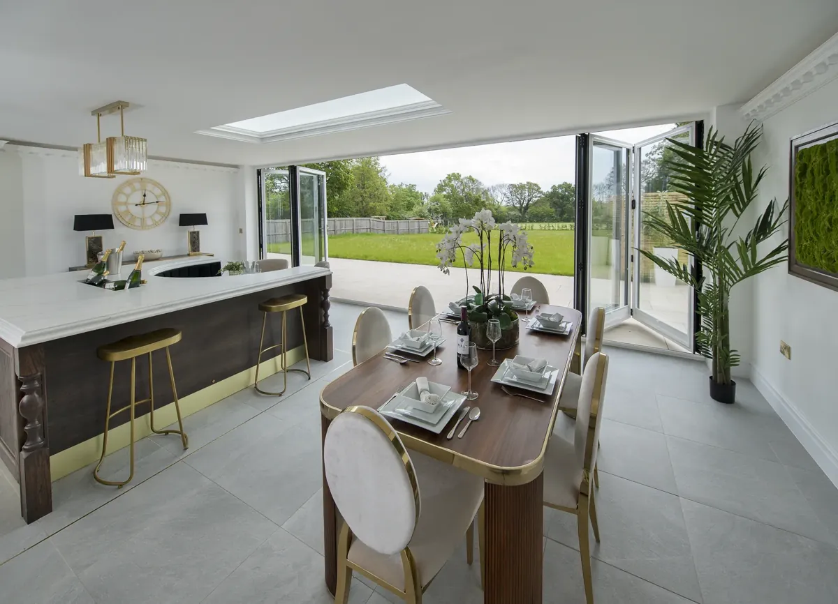 Bifold doors open from a kitchen diner onto the garden