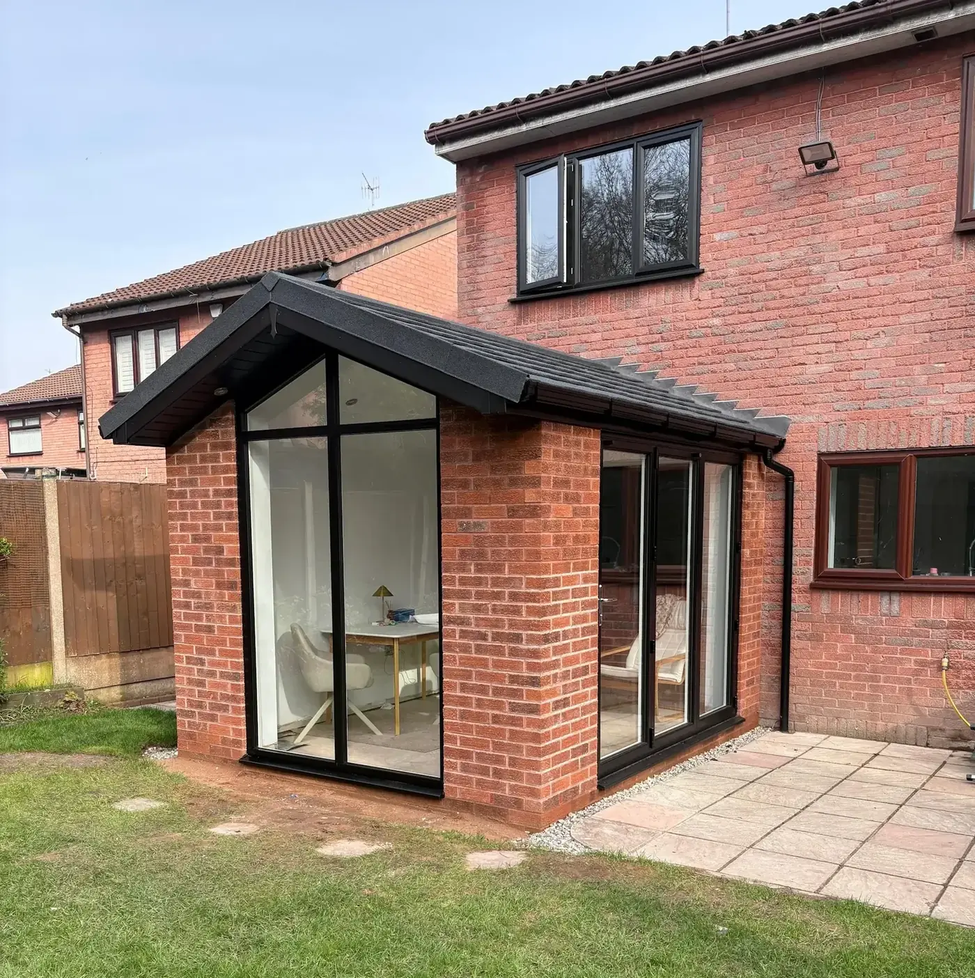 A conservatory with a solid tiled roof