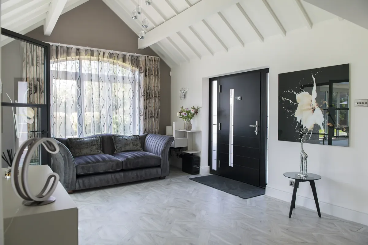 An entrance hall with a steel-look screen and front door