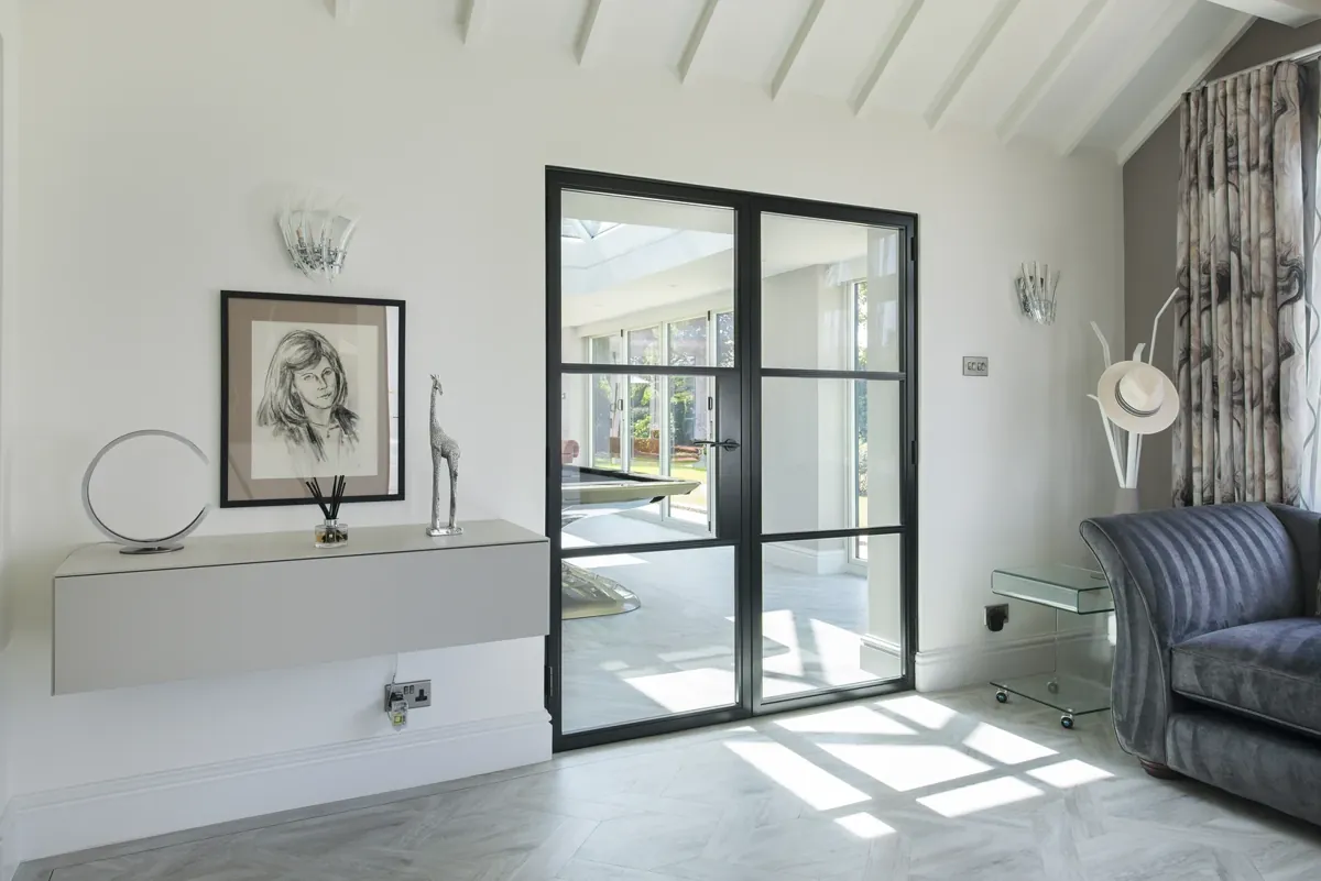 An internal steel-look screen and door in a hallway