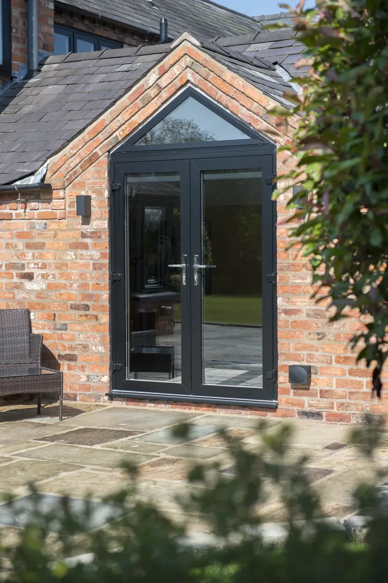 French doors set into a brick gable