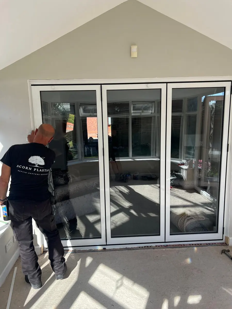 New three-panel aluminium bifold doors being fitted