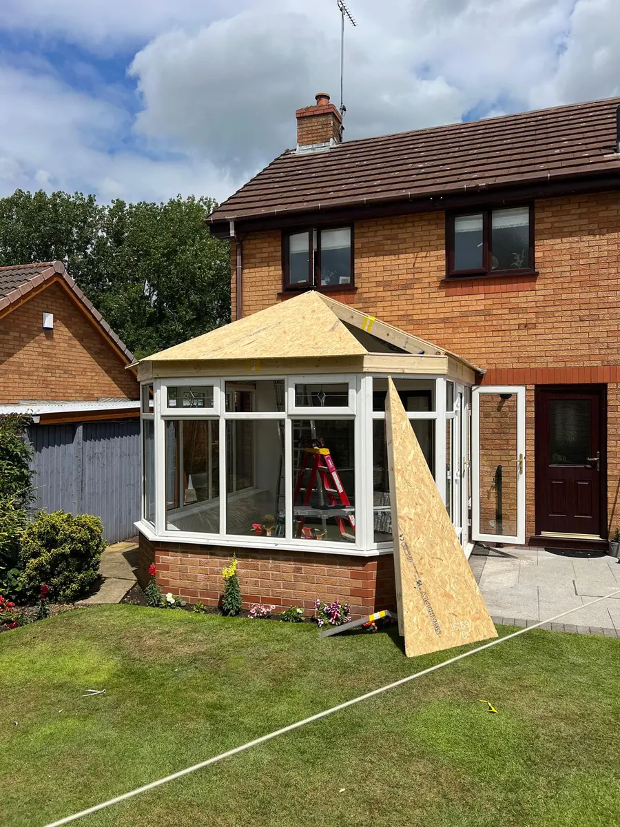 The new insulated roof structure boarded out over the conservatory