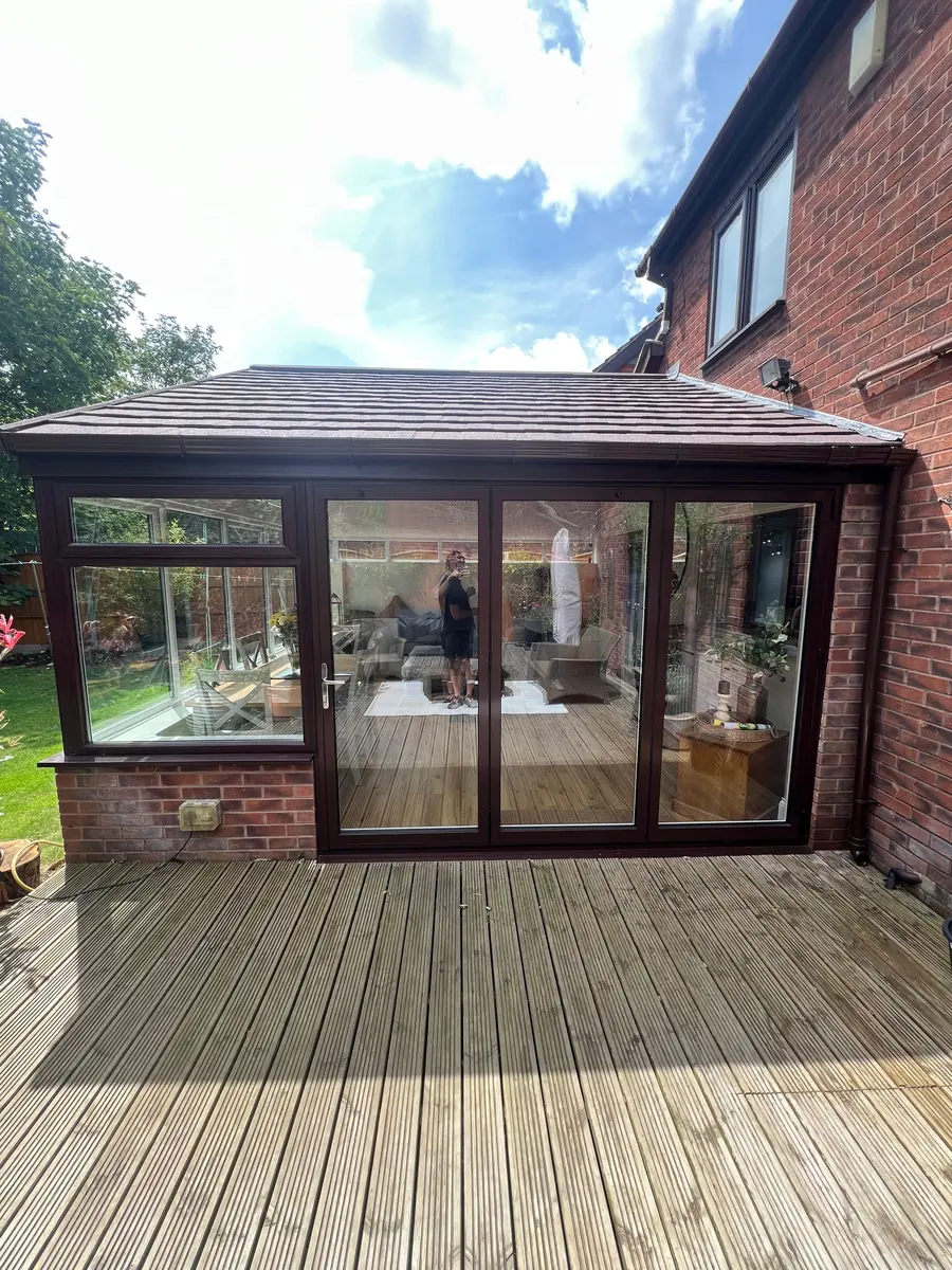 The finished three-pane aluminium bifold doors onto the decking