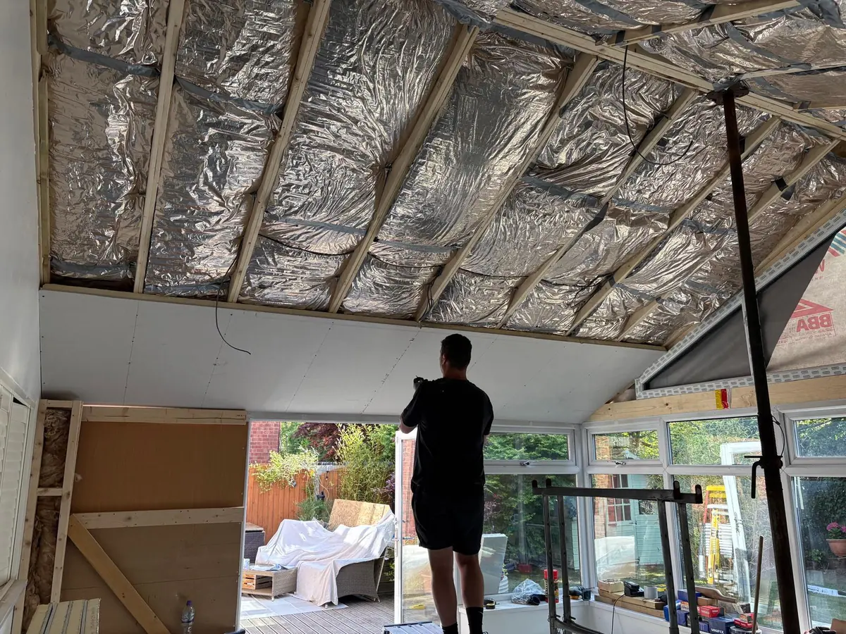 Insulation fitted inside the new conservatory roof before boarding