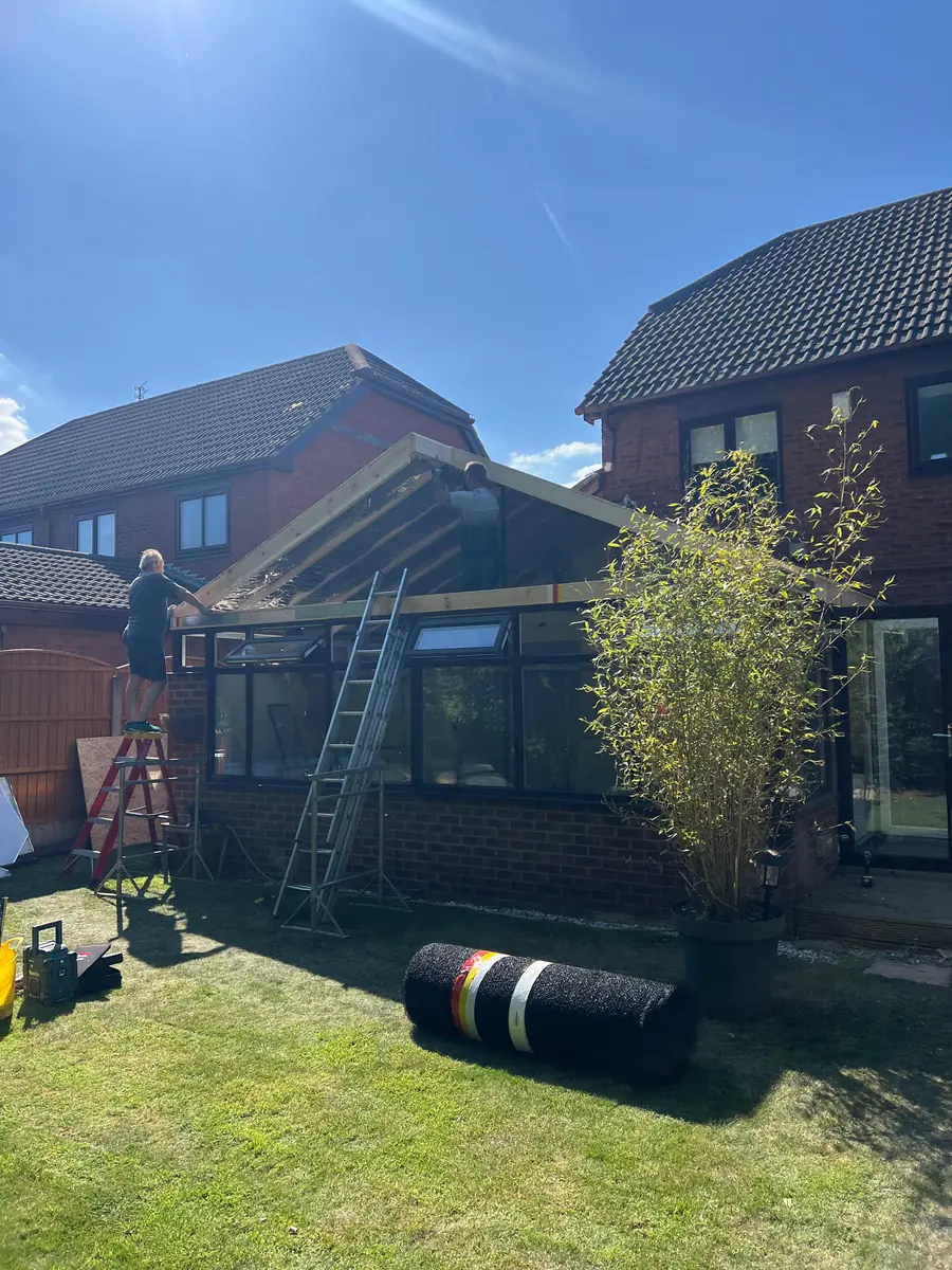 The new lightweight tiles being fitted to the conservatory roof