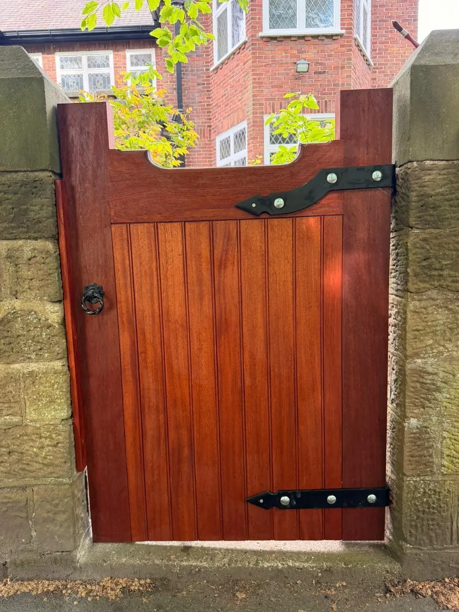 The finished hardwood gate closed in the opening