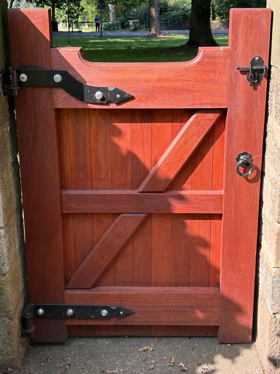 The heavy-duty strap hinge and latch on the new gate
