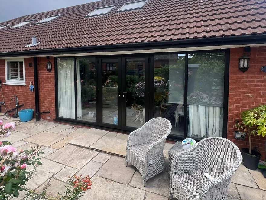 The finished black French doors onto the patio