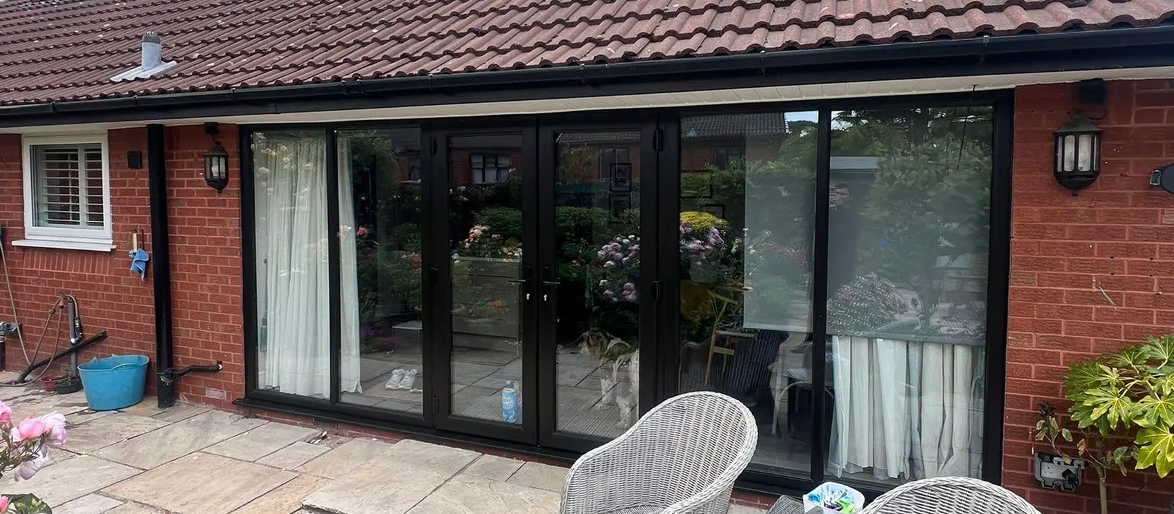 The finished black French doors onto the patio
