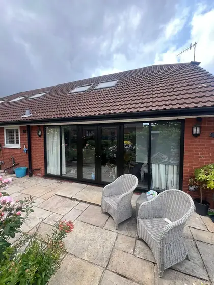 The finished black French doors onto the patio