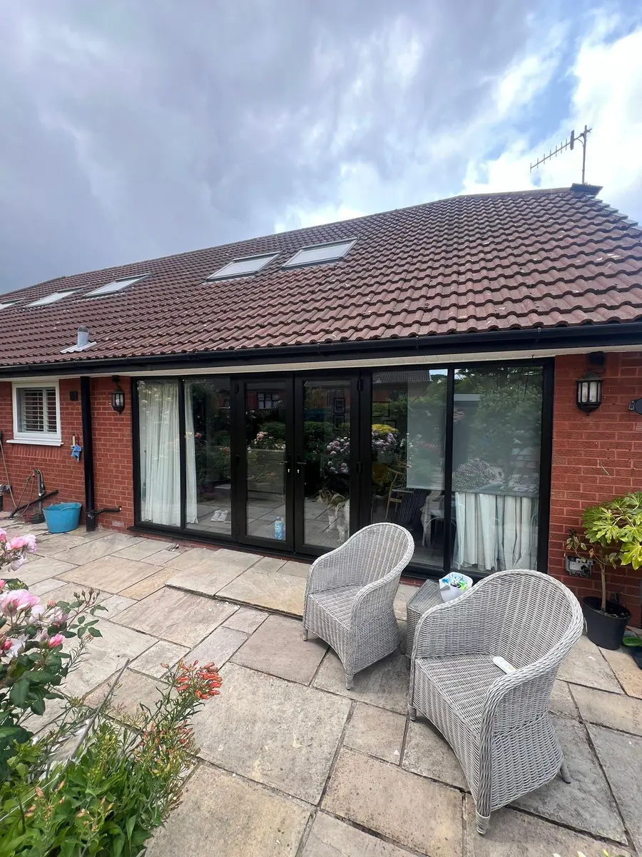 The finished black French doors onto the patio