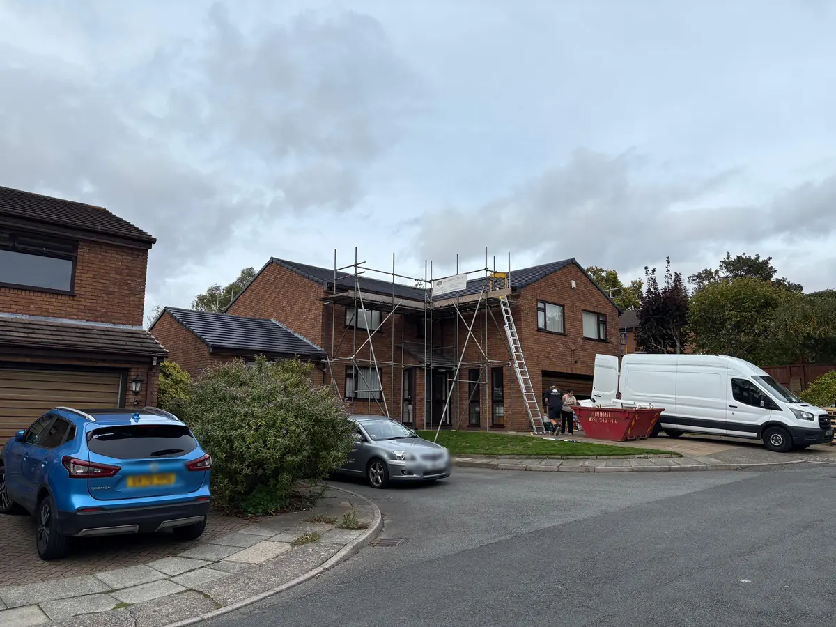 The house scaffolded with the roof strip under way