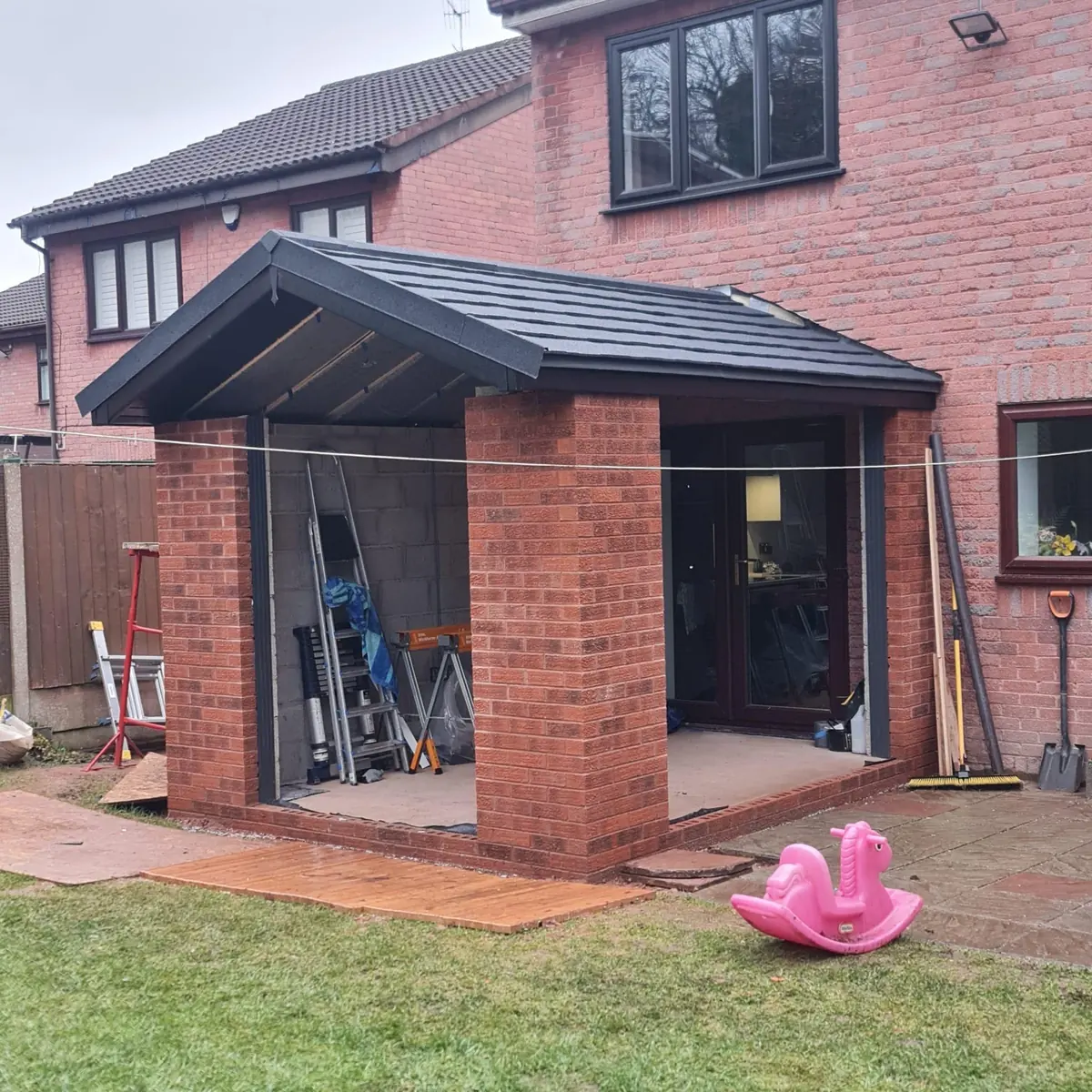 The tiled roof on and the gable glazing fitted