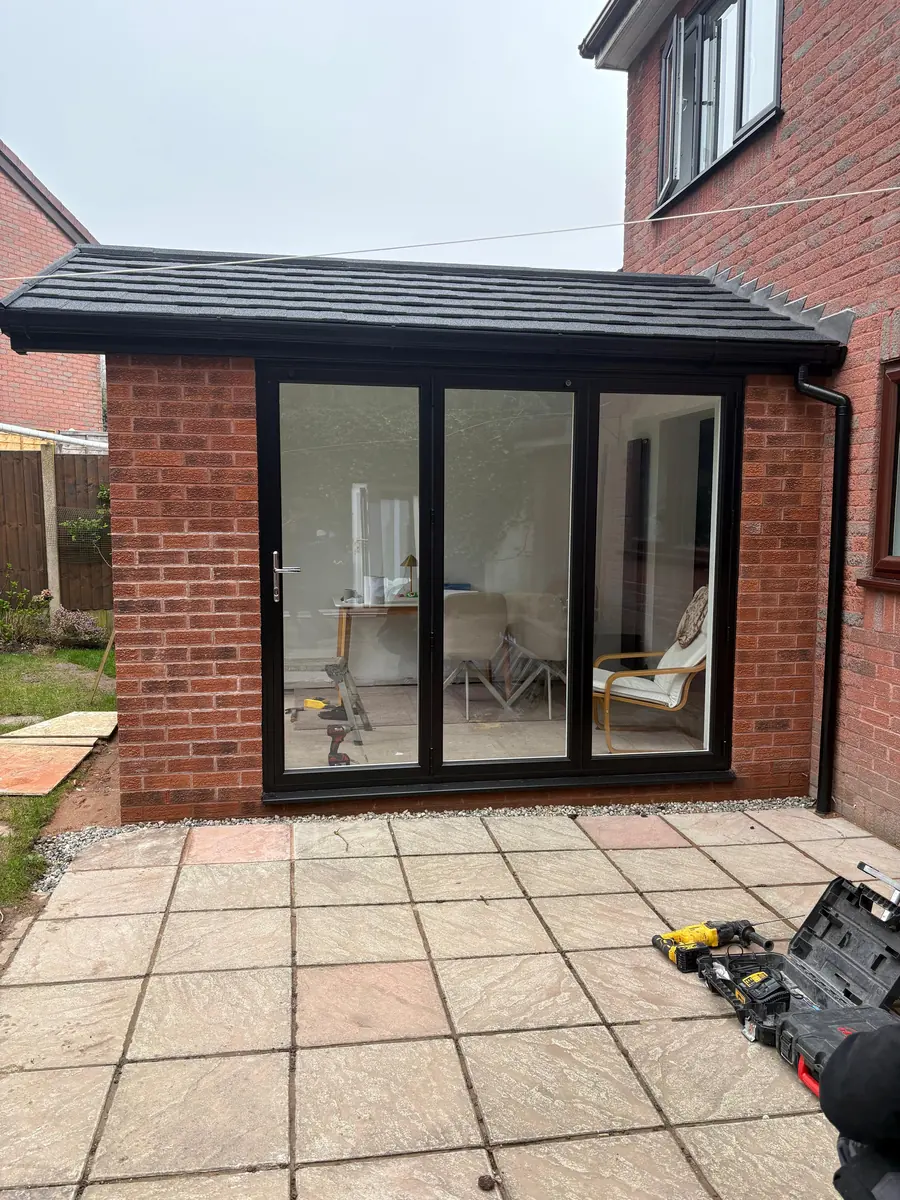 The finished black aluminium sliding doors onto the patio