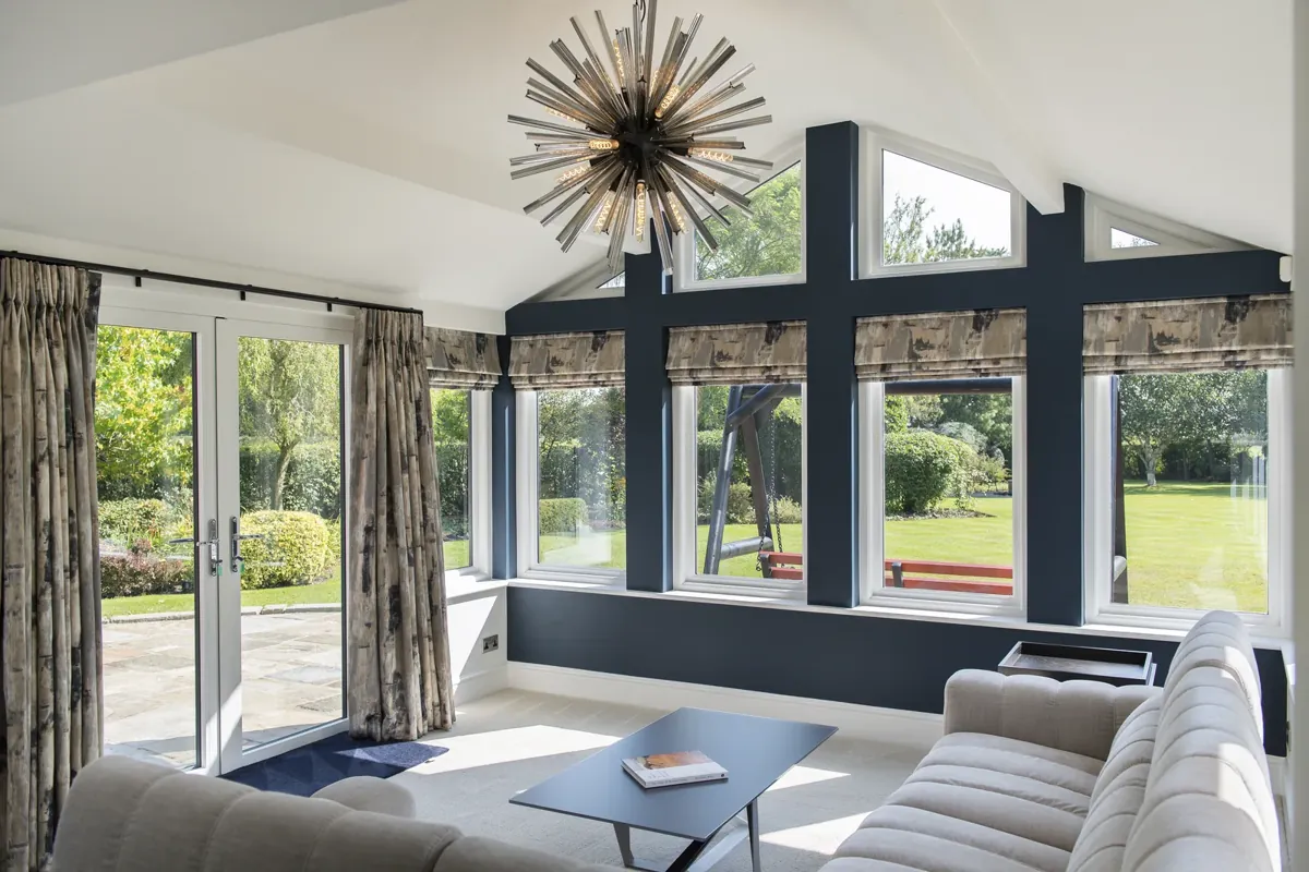 A wide view of an orangery lounge with garden glazing