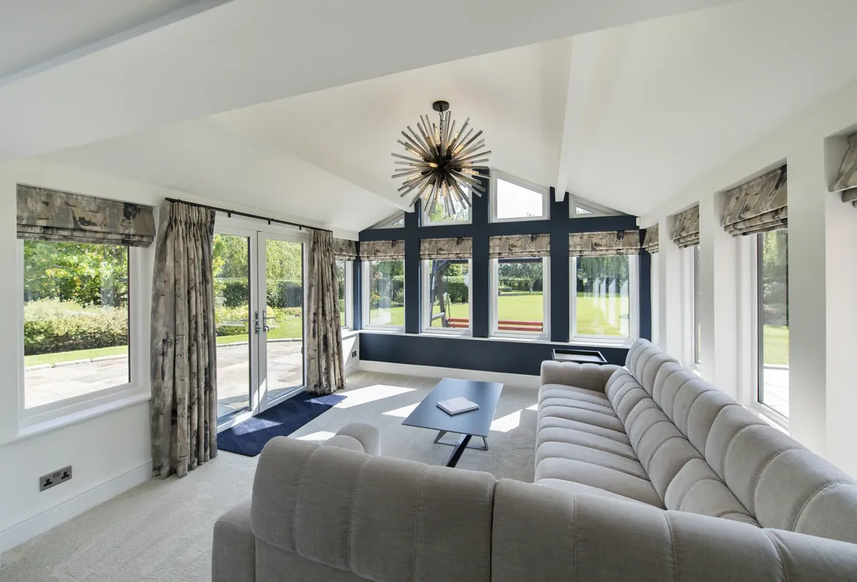 An orangery lounge with full-height glazing