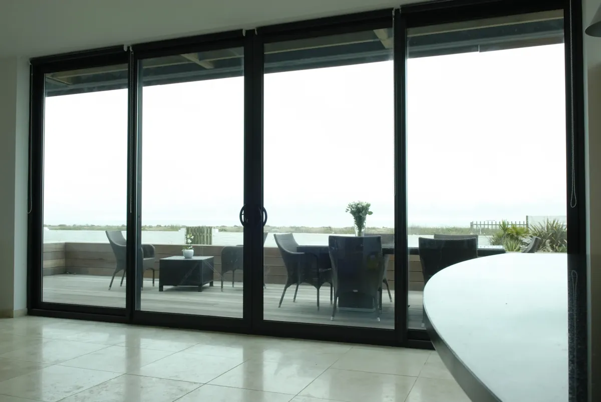 A wide sliding patio door looking out over a terrace