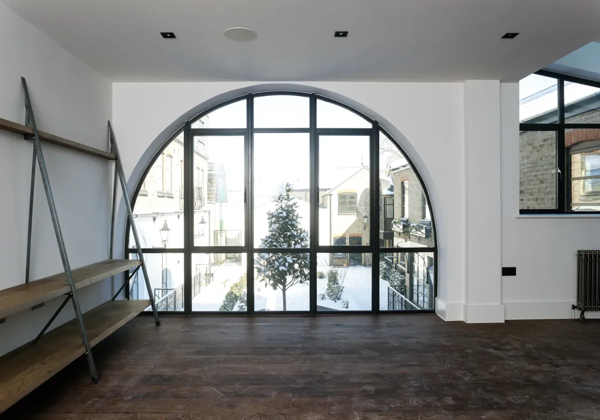 A wide arched steel-look screen in a living space