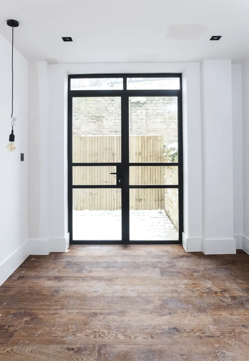 Steel-look double doors to a rear courtyard