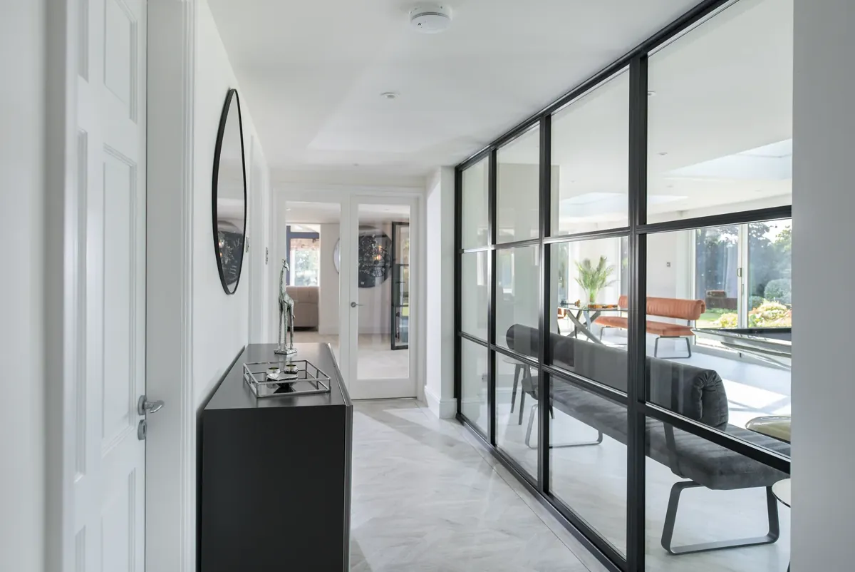A steel-look sliding screen dividing a hallway