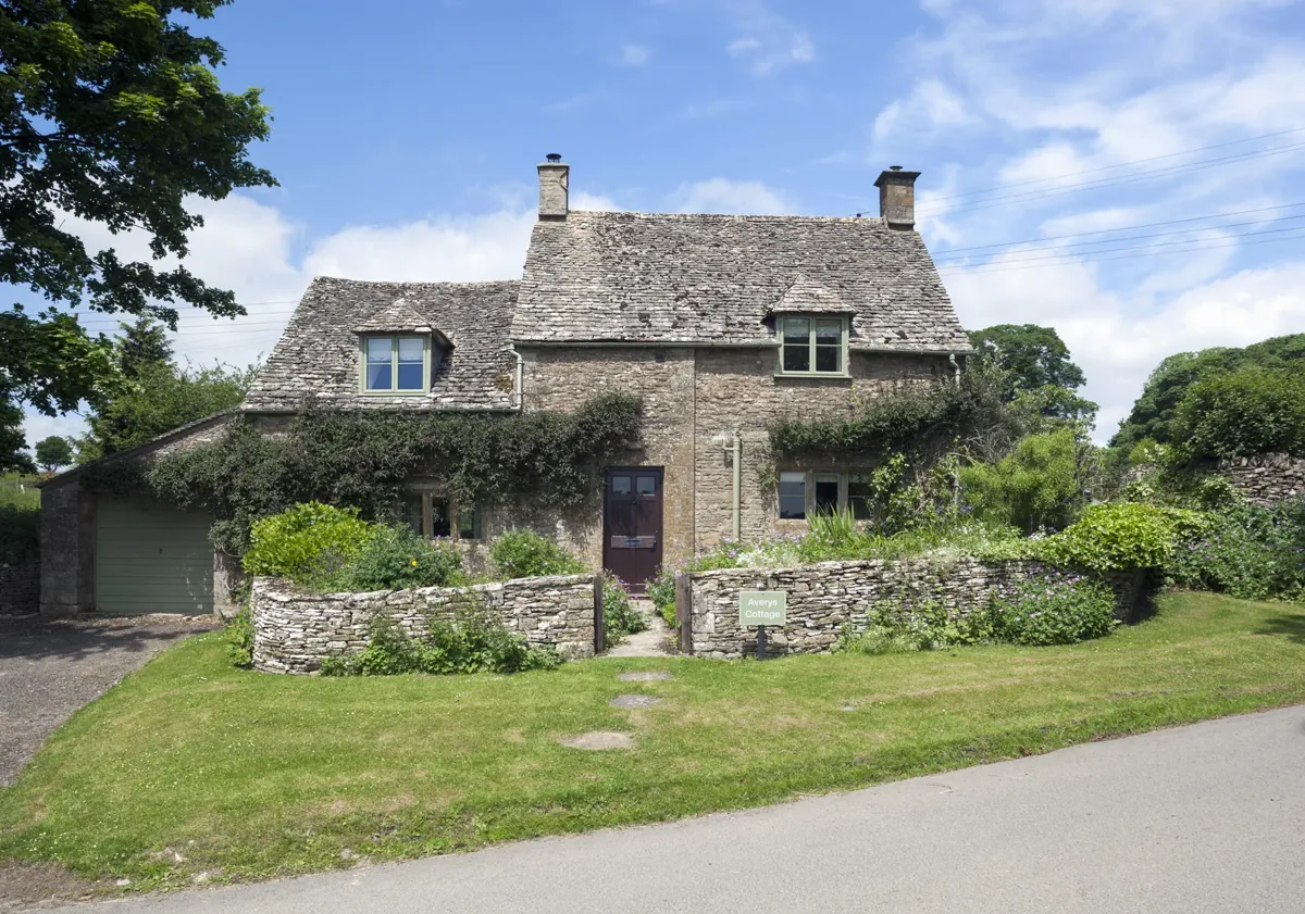 A stone cottage seen from the lane
