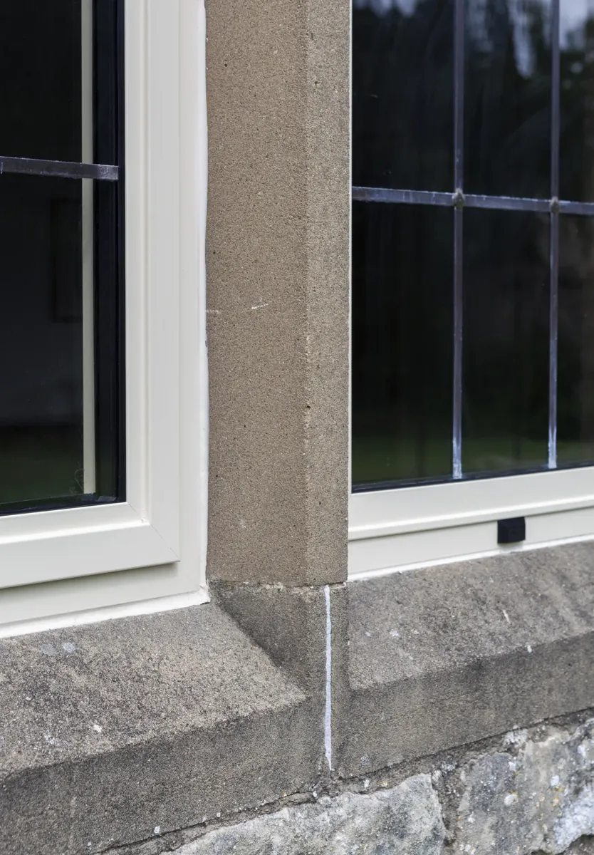 Close detail of a steel-look window and stone mullion