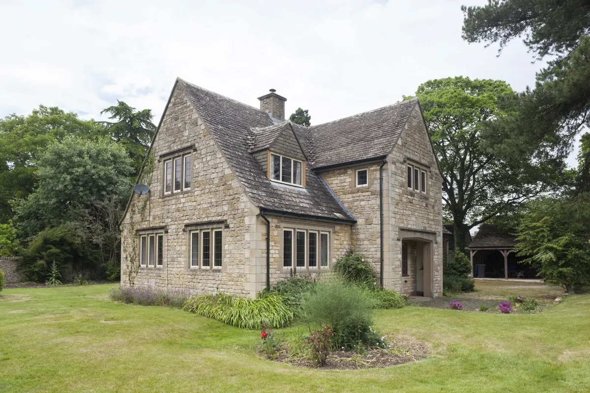 A large stone house with steel-look windows